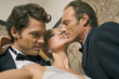 Close-up of a mature man and a young man romancing with a young woman