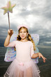 A young girl wearing a fairy costume