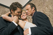 Close-up of two men romancing with a young woman