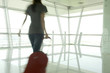 A woman walking through an airport