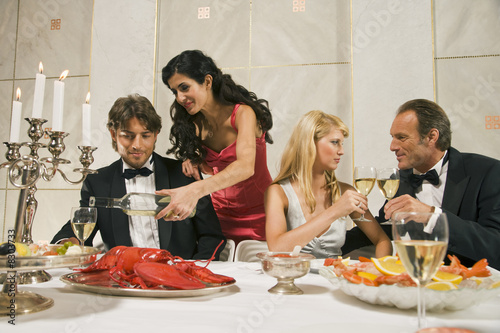 Photo: Two couples at the dining table Two couples at the dining table