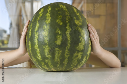 Photo: Young girl holding watermelon Young girl holding watermelon