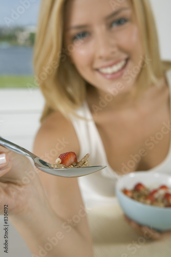 Photo: Close-up of woman holding spoonful of cereal Close-up of woman holding spoonful of cereal