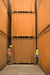 Side profile of two dock workers walking at a commercial dock