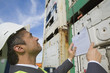 Side profile of a businessman holding a clipboard