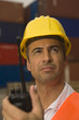 Close-up of a dock worker holding a walkie-talkie
