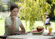 A woman looking sad and pensive sitting in the garden