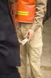 Mid section view of a businessman bribing a dock worker