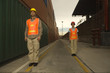 Two dock workers standing at a commercial dock