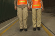 Photo: Low section view of two dock workers holding each other's hands at a commercial dock Low section view of two dock workers holding each other's hands at a commercial dock