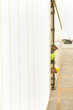 Portrait of two dock workers peeking from behind a cargo container