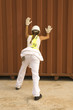 Rear view of a female dock worker pushing a cargo container