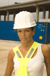 Portrait of a female dock worker wearing a hardhat