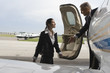 Photo: Pilot helping a cabin crew at the door of a private airplane Pilot helping a cabin crew at the door of a private airplane