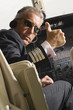 Pilot making thumbs up sign in the cockpit of a private airplane
