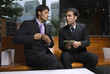 Businessmen cutting a deal with money