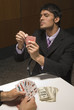 Businessmen playing cards for money