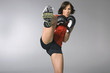 Young woman kickboxing, studio shot