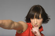 Young woman fist punching, studio shot