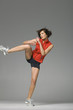 Young woman kickboxing, studio shot