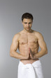 Young man in towel meditating
