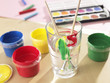 Close-up of a glass of water with watercolor paints