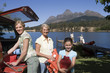 Photo: Girl (8-10) unloading life jackets from SUV with mother and grandmother, rest of family on lake jetty beside boat Girl (8-10) unloading life jackets from SUV with mother and grandmother, rest of family on lake jetty beside boat