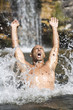 Young man swimming in a natural pool