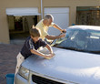 Father and son washing a car