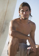 A surfer sitting on a beach
