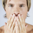 A male nude, hands over mouth