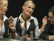 Happy woman with cash at poker game