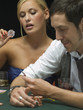 Woman holding ice cube at poker game