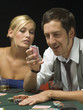 Man looking at playing cards at poker game