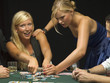 Upset woman taking poker chips at poker game
