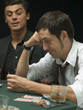 Worried man looking at playing cards at poker game