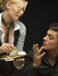Woman showing man cash at poker game
