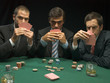Men holding playing cards at poker game