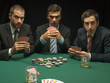 Shocked men playing poker