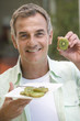 A man eating kiwi fruit