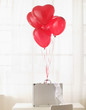 Briefcase with heart shaped balloons and bra