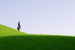 A businessman with a suitcase walking down hill