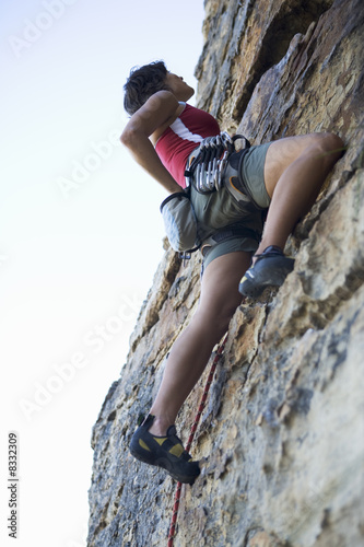 Photo: A climber climbing a rock face A climber climbing a rock face