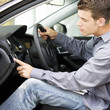 A young man admiring a new car