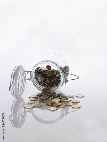 Photo: Tipped over jar of Euro coins Tipped over jar of Euro coins