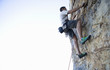 A climber climbing a rock face
