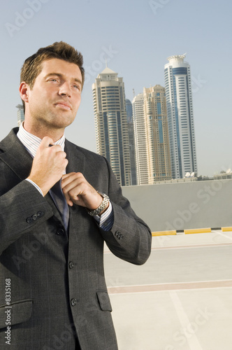 Photo: A businessman adjusting his tie A businessman adjusting his tie
