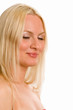 A portrait of a blonde woman with eyes closed