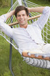 Man relaxing in hammock smiling Man relaxing in hammock smiling