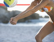 A woman playing beach volleyball